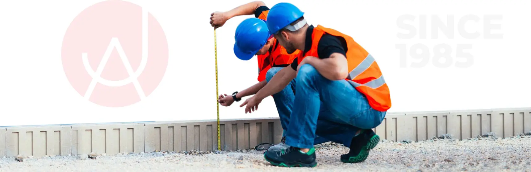 Two Construction Workers Taking Measurements of a Wall